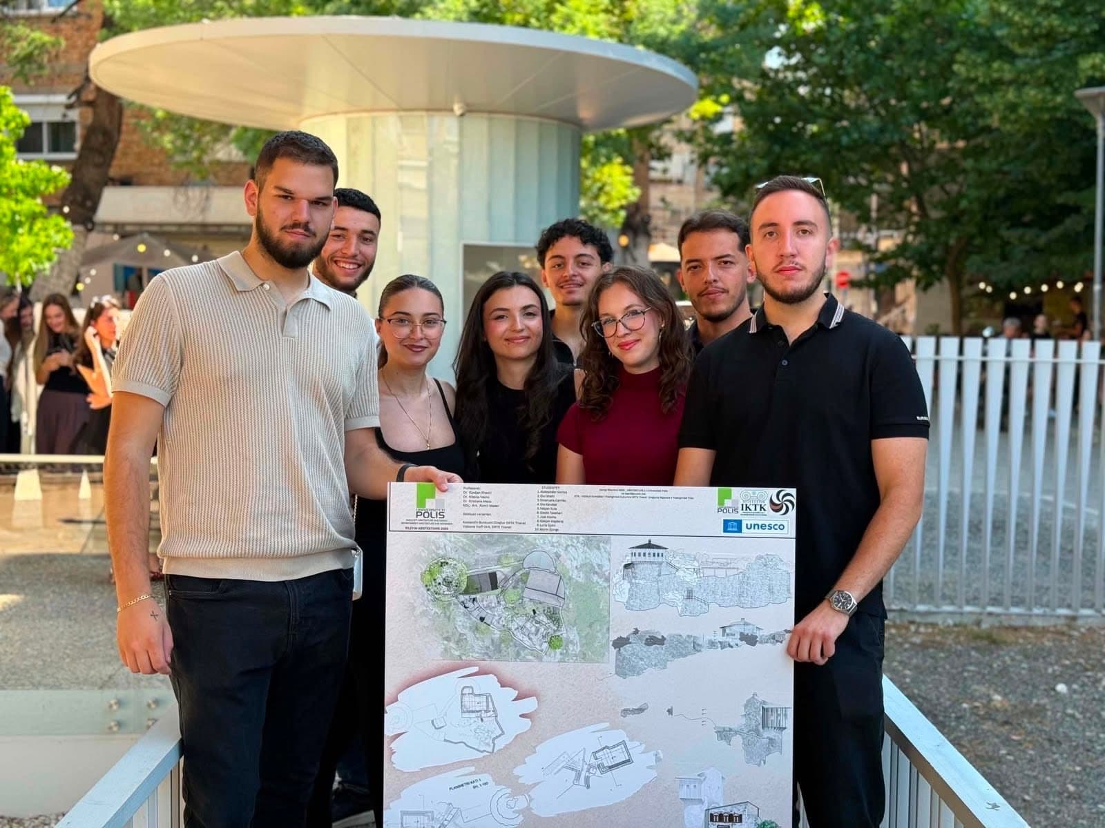 POLIS University architecture students standing with their survey poster at the closing exhibition of Architectural Survey 2026, held at Mozaiku i Tiranës.